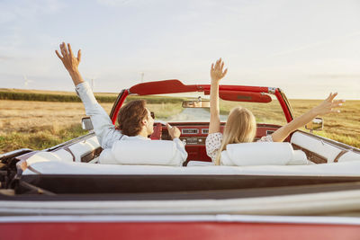 Rear view of woman sitting in car