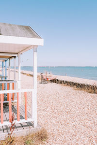 Beach huts against clear sky
