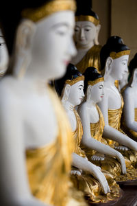 Close-up of buddha statues in store