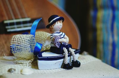 Close-up of doll with toy boat