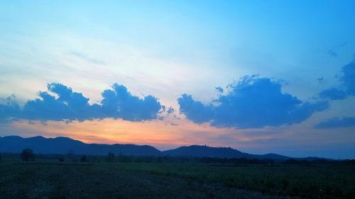 Scenic view of field against sky during sunset