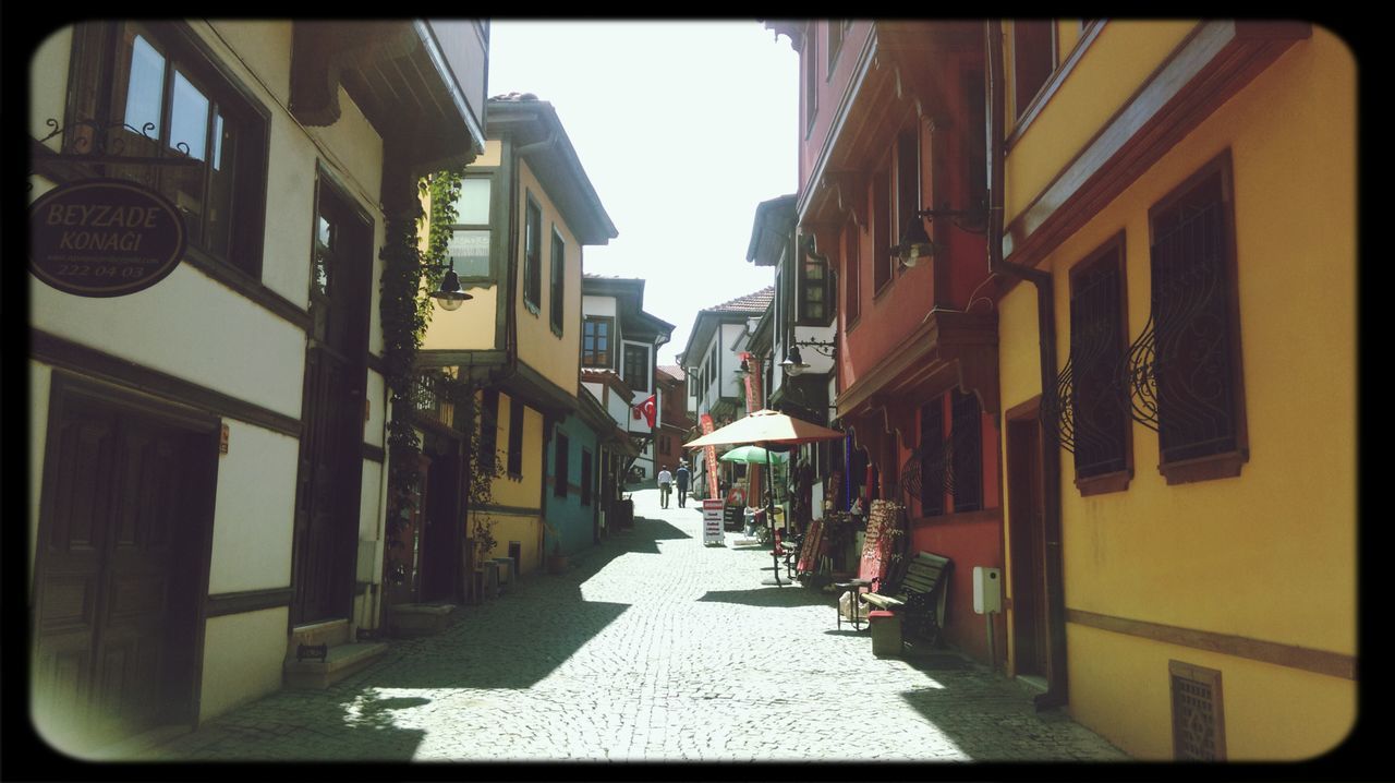 building exterior, architecture, built structure, transfer print, street, residential building, residential structure, auto post production filter, city, the way forward, building, alley, narrow, house, diminishing perspective, cobblestone, residential district, city life, incidental people, day