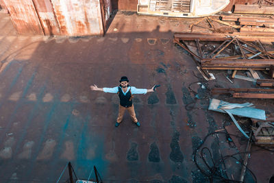 Full length of man standing against wall