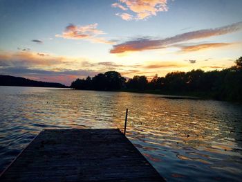 Scenic view of calm lake at sunset