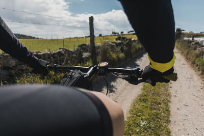 Cyclist riding bicycle on sunny day