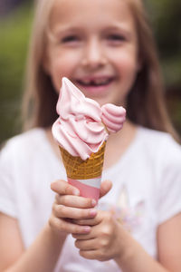 Midsection of woman holding ice cream cone