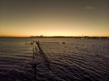 Scenic view of sea against clear sky at sunset