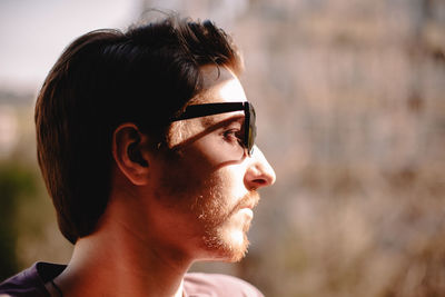 Close up portrait of young depressed man wearing sunglasses