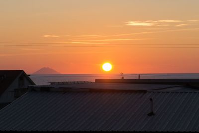 Scenic view of sea against orange sky