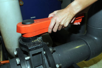 Close-up of person working on metal