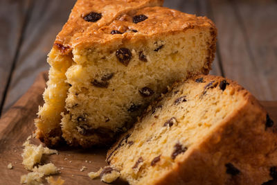 Slices of home made cake with raisins on wooden plate close up