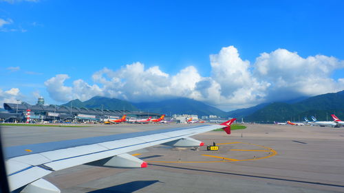 Airplane on runway against sky