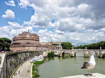 View of bridge over river against cloudy sky