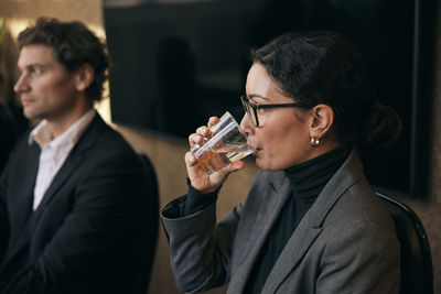 Side view of business colleagues working at office