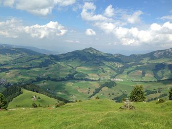 Scenic view of landscape against cloudy sky