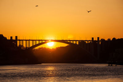 View of bridge over sea against sky during sunset