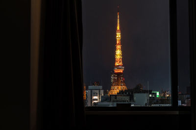 Illuminated building against sky at night