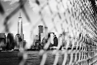 One world trade center seen through chainlink fence