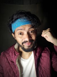 Portrait of mature man against black background