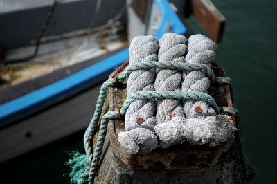 Close-up of ropes tied on bollard