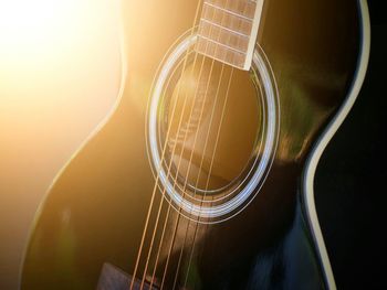 Close-up of guitar against black background