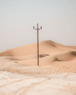 Sand dunes in desert against sky