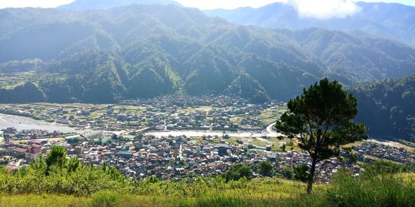 Aerial view of townscape against mountains