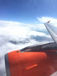 Cropped image of airplane against cloudy sky