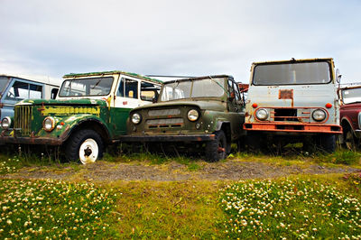 Abandoned truck on field against sky