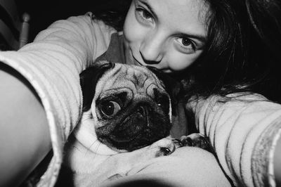 Portrait of happy woman holding dog