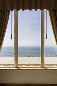 Scenic view of sea seen through window