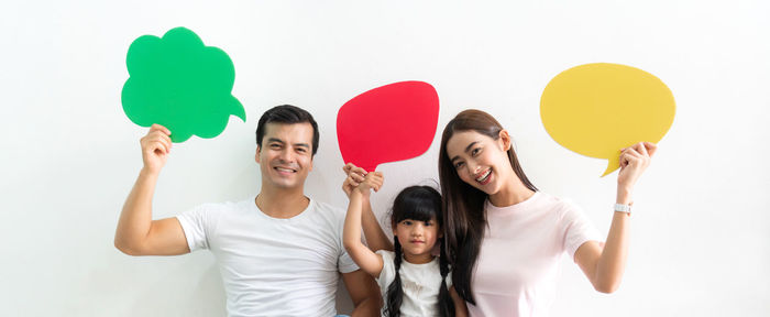 Portrait of a smiling young couple against white background