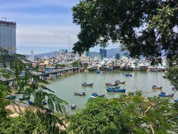 Boats moored on lake in city