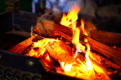 Close-up of bonfire on wood at night