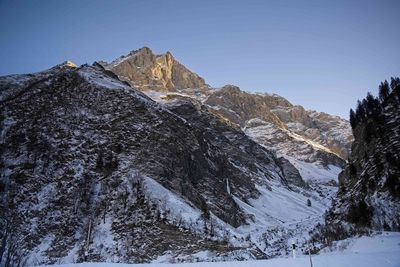 Scenic view of snowcapped mountains against clear sky