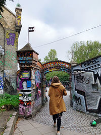 Rear view of woman walking on street in city