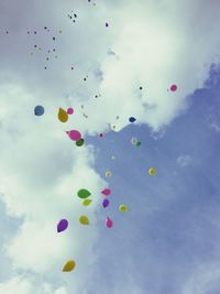 Low angle view of balloons against sky