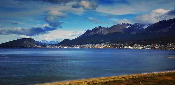 Scenic view of sea and mountains against sky