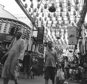 Low angle view of people walking in market