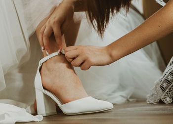 Low section of woman tying shoelace