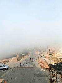 Scenic view of landscape against foggy sky