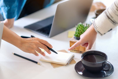 Cropped image of businesswoman discussing in office