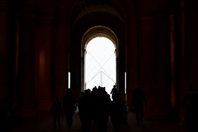 Silhouette people in corridor of building