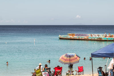People on beach against sky