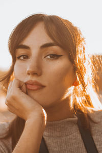 Close-up portrait of young woman looking at camera