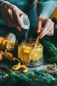 Autumn or winter hot tea with lemon and sugar with steam above the cup on a dark background