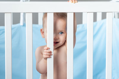 High angle view of baby boy sleeping on bed