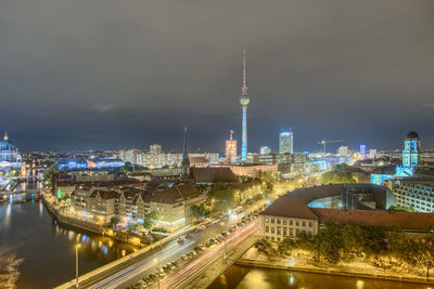 Illuminated city against sky at night