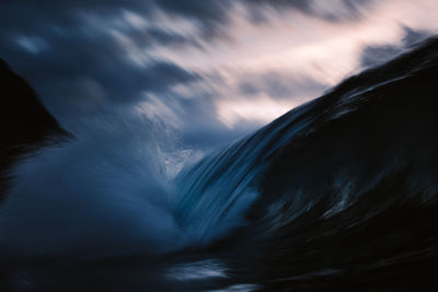 Close-up of waterfall against sky during sunset