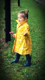 Close-up of girl standing on grassy field